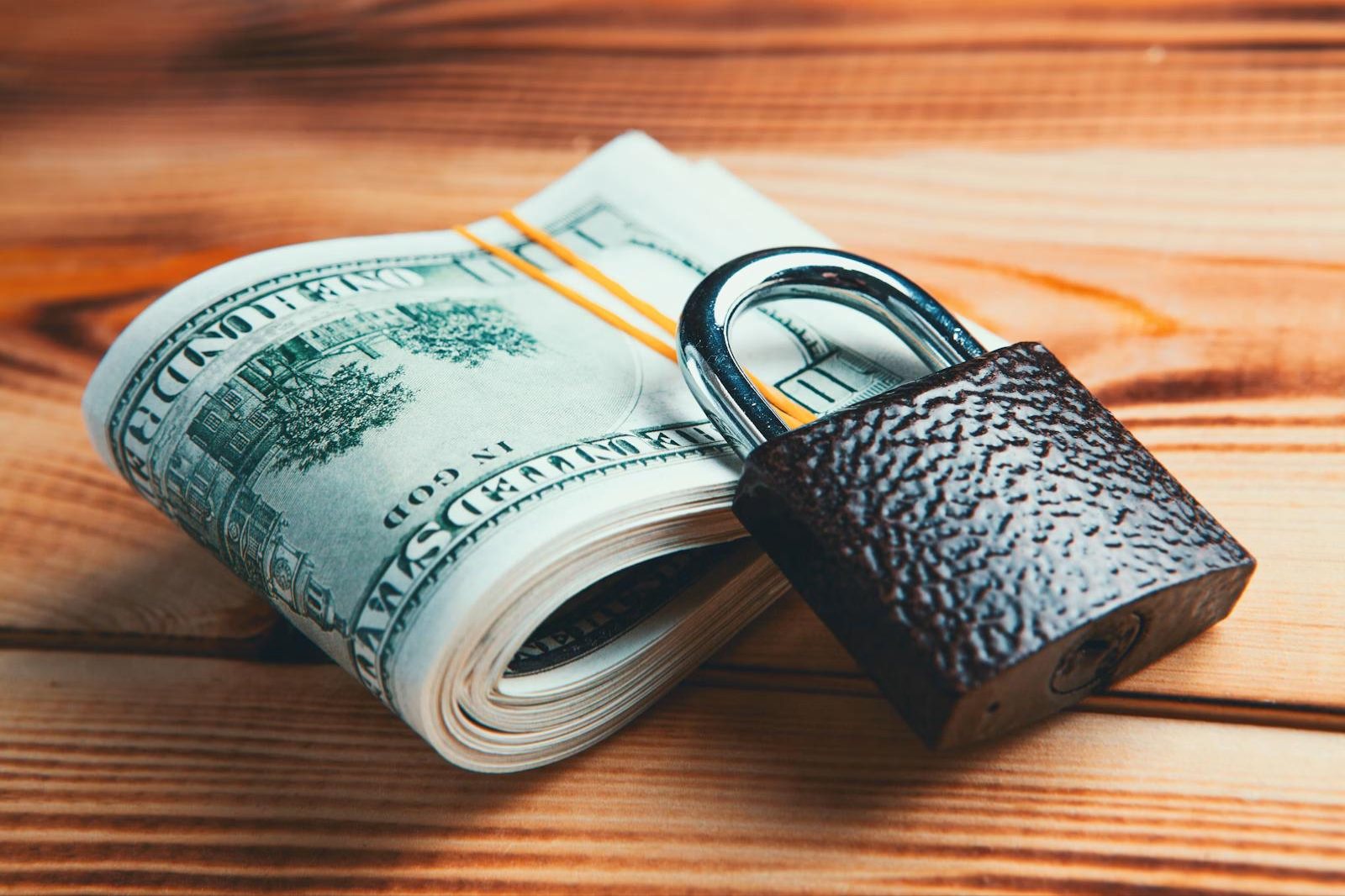 Rolled US dollar bills secured with a padlock